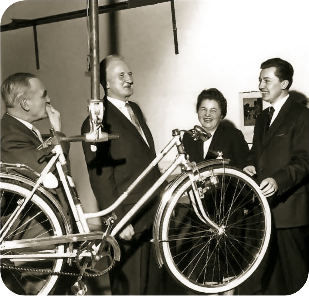 A man and a woman, both smiling, wearing "Deutsche company bike" T-shirts.